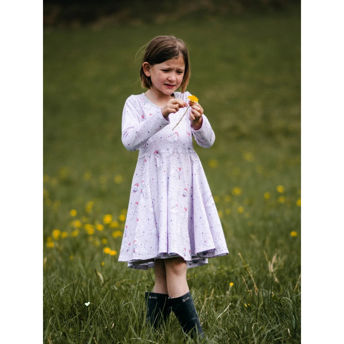 WinterWUNDERkleid Schnittmuster – Mädchen im hellen Winterwunderkleid auf der Wiese (genähtes Designbeispiel)