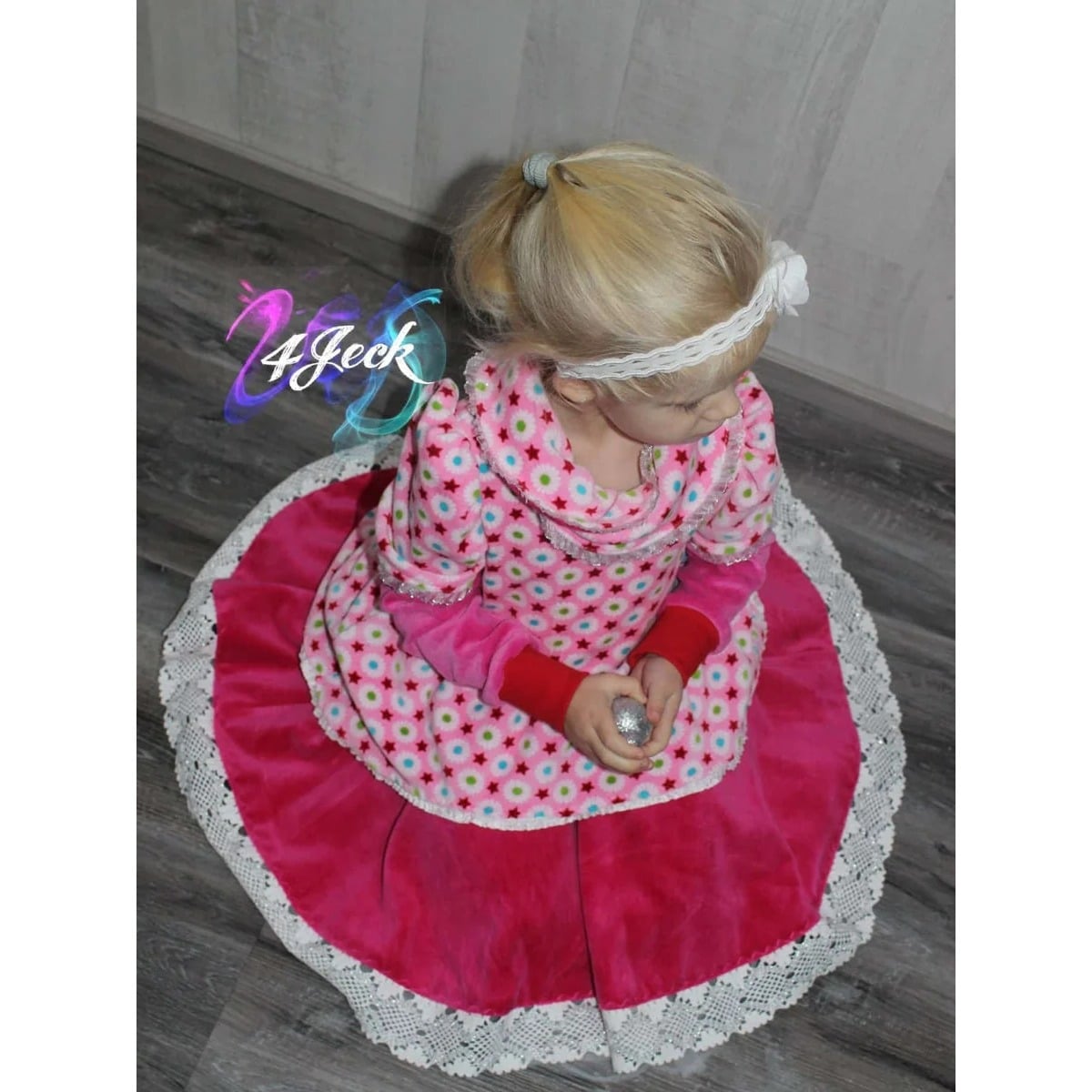 WinterDreams Kleid Schnittmuster – pinkes WinterDreams-Kleid mit Fellkragen, Mädchen sitzend (genähtes Designbeispiel)