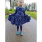 Winterzauberkleid Schnittmuster – Mädchen im dunkelblauen Winterzauberkleid auf einem Weg (genähtes Designbeispiel)