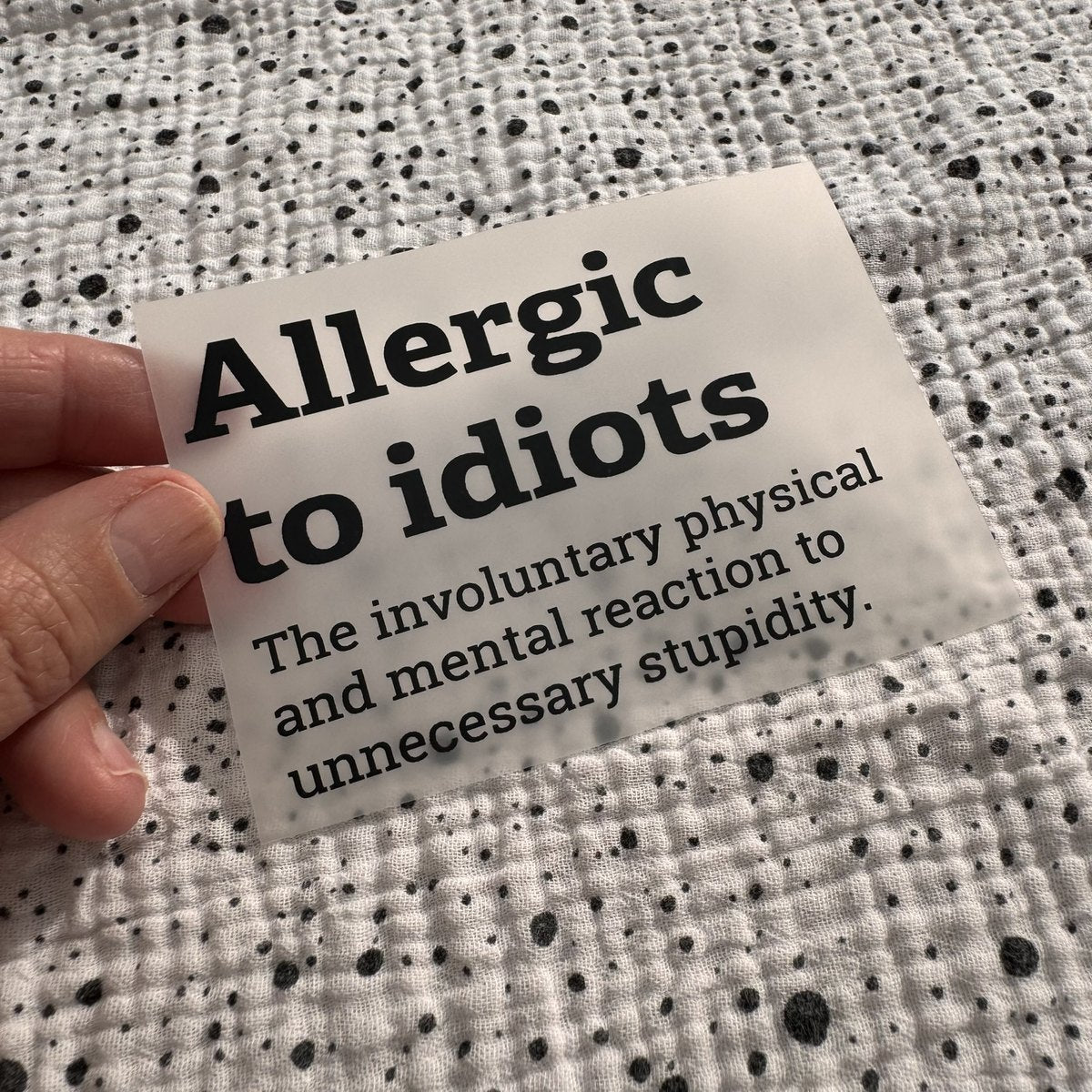 Bügelbild Allergic to idiots klein in Schwarz, ca. 10 x 7 cm, in der Hand gehalten