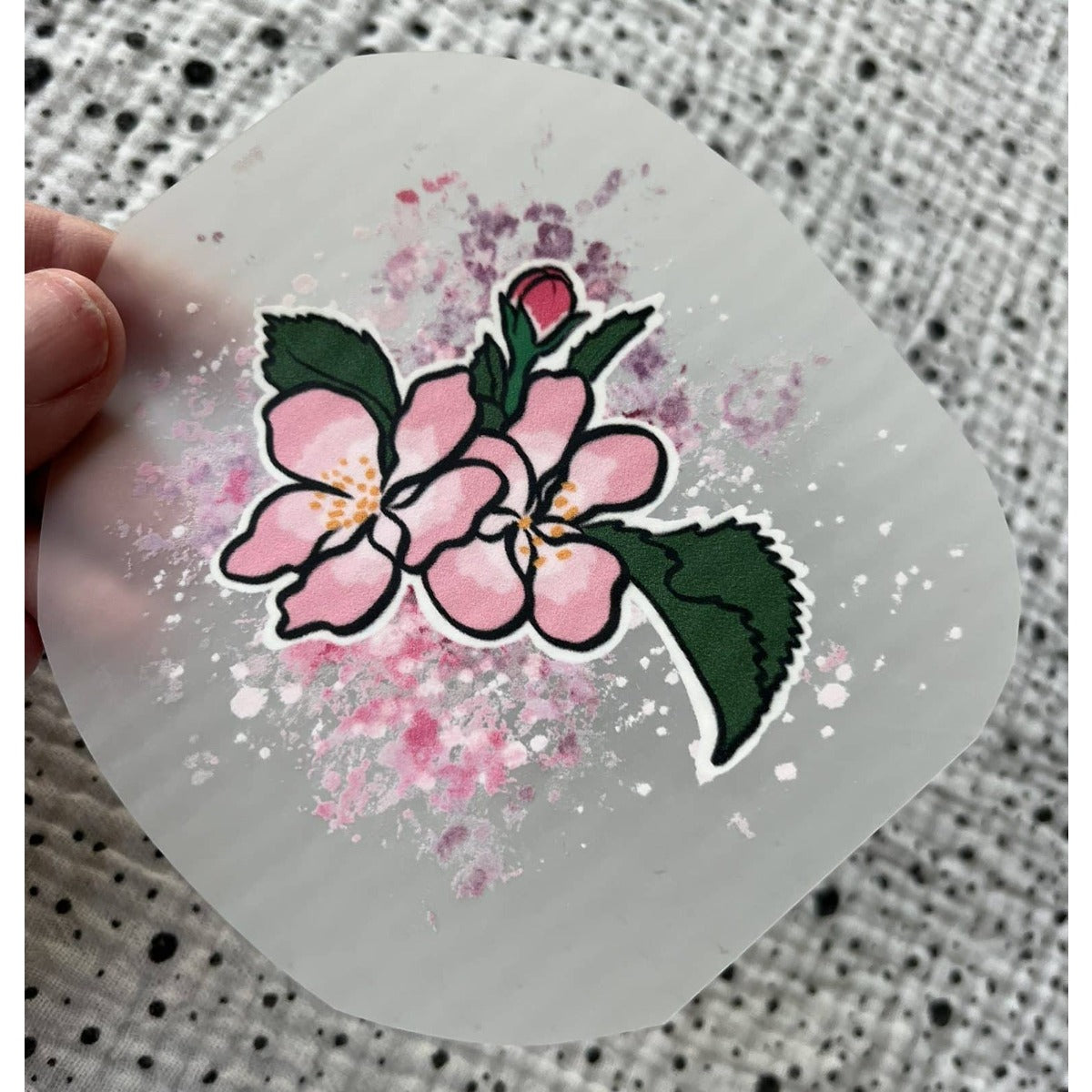 Bügelbild Apfelblüte – rosa Blütenzweig, in der Hand gehalten