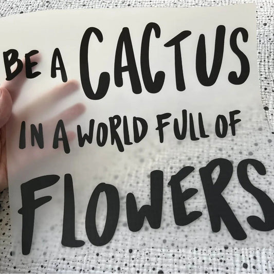 Bügelbild Be a cactus – Schriftzug „Be a cactus in a world full of flowers“ in Schwarz