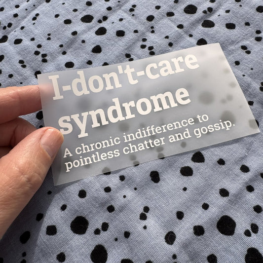 Bügelbild I-don't-care syndrome klein in Weiß, ca. 10 x 5,5 cm, in der Hand gehalten
