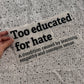 Bügelbild Too educated for hate groß in Schwarz, ca. 29,5 x 15 cm, in der Hand gehalten