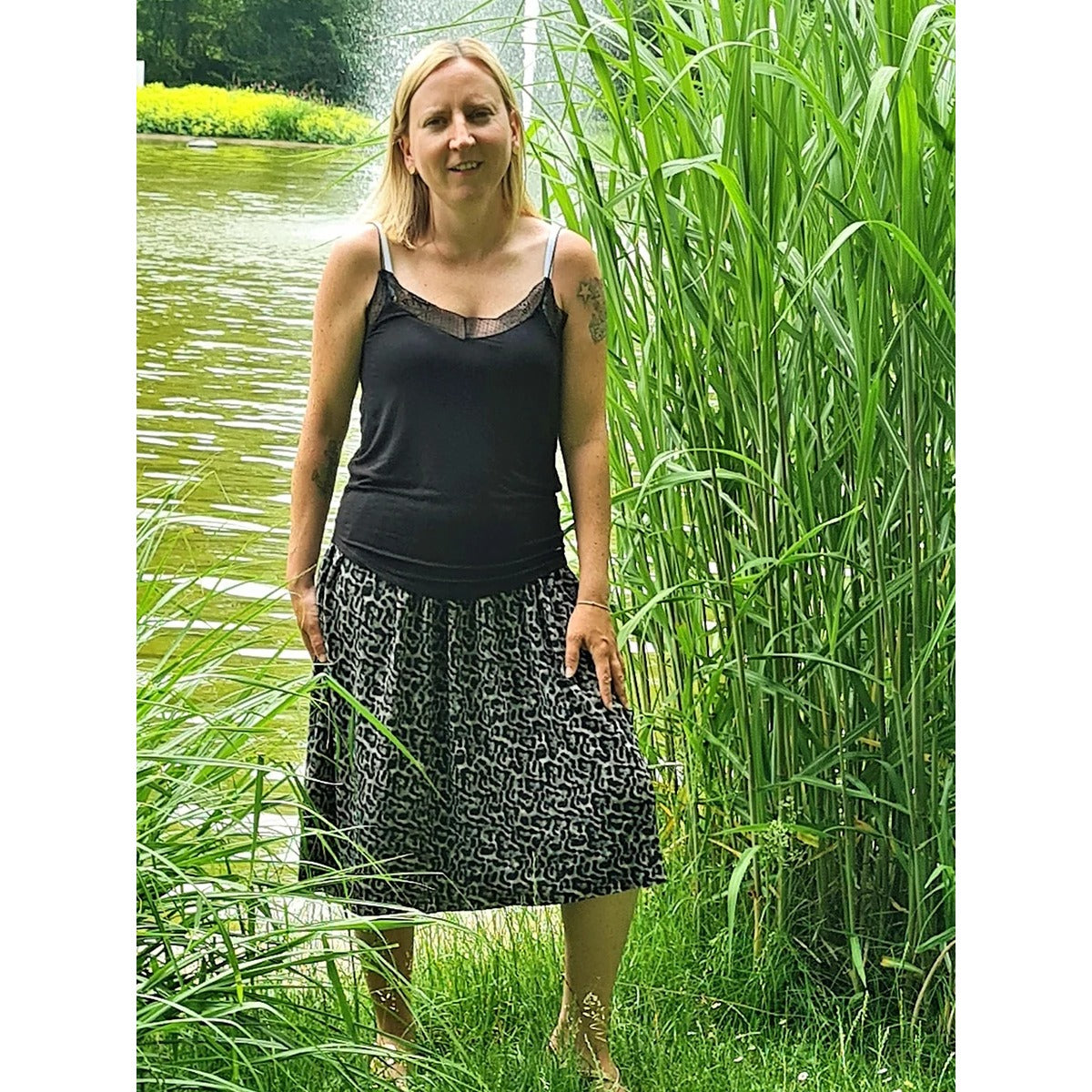 Plisseerock Damen – schwarz-beige gemusterter Plisseerock mit schwarzem Top